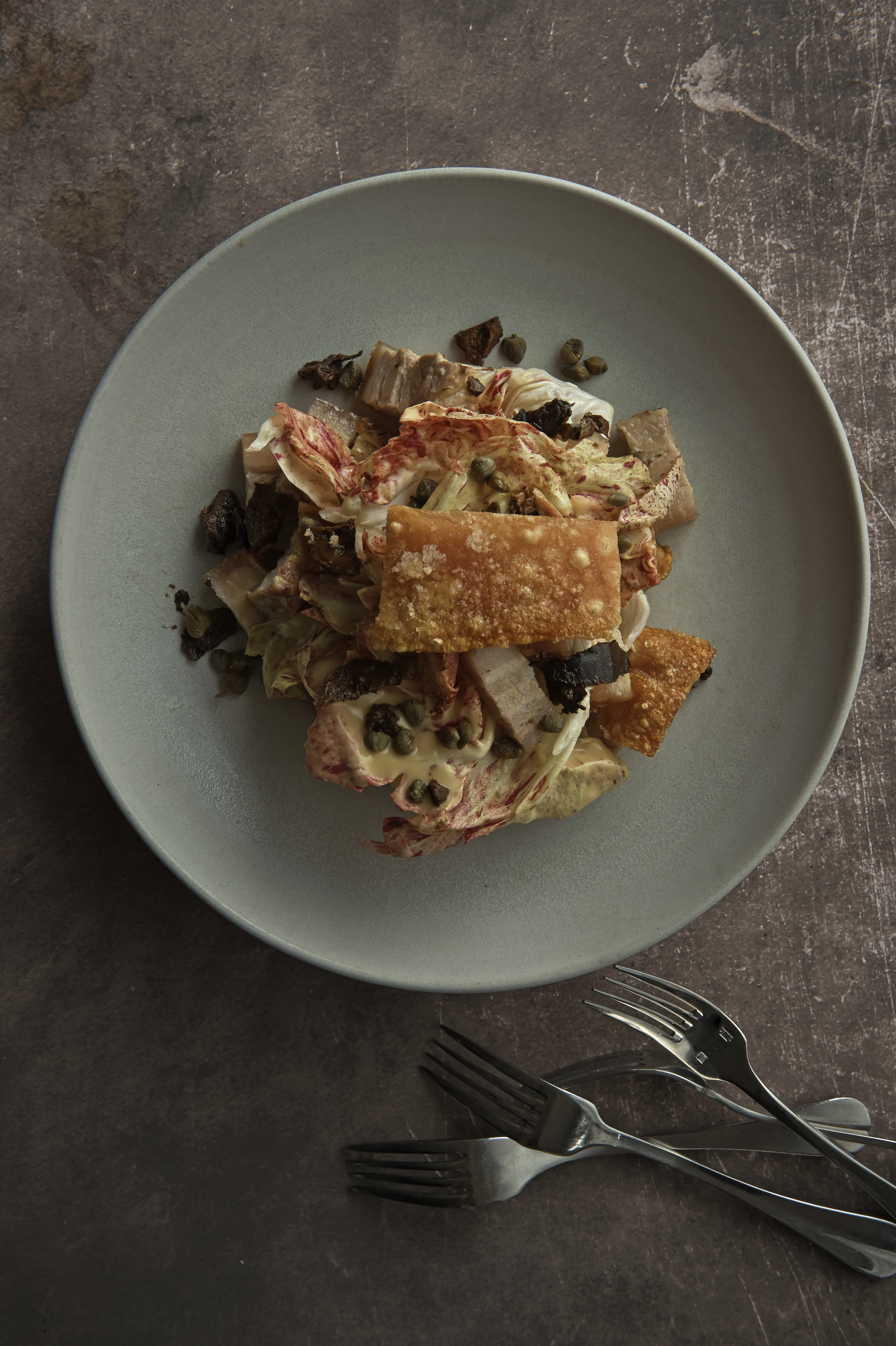 Roast pork belly salad with pickled walnuts and radicchio 