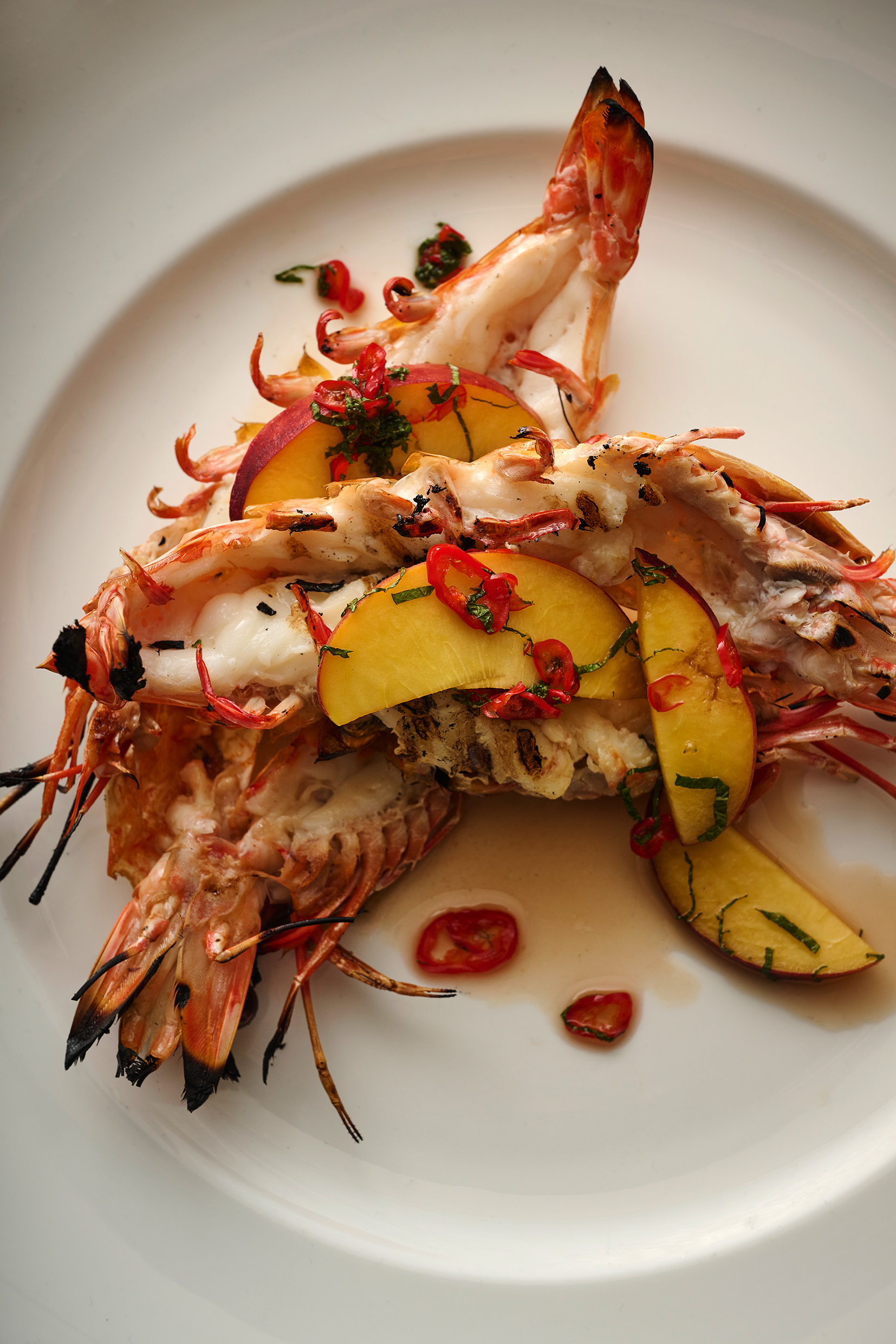 Barbecue tiger prawns with peach and chilli dressing