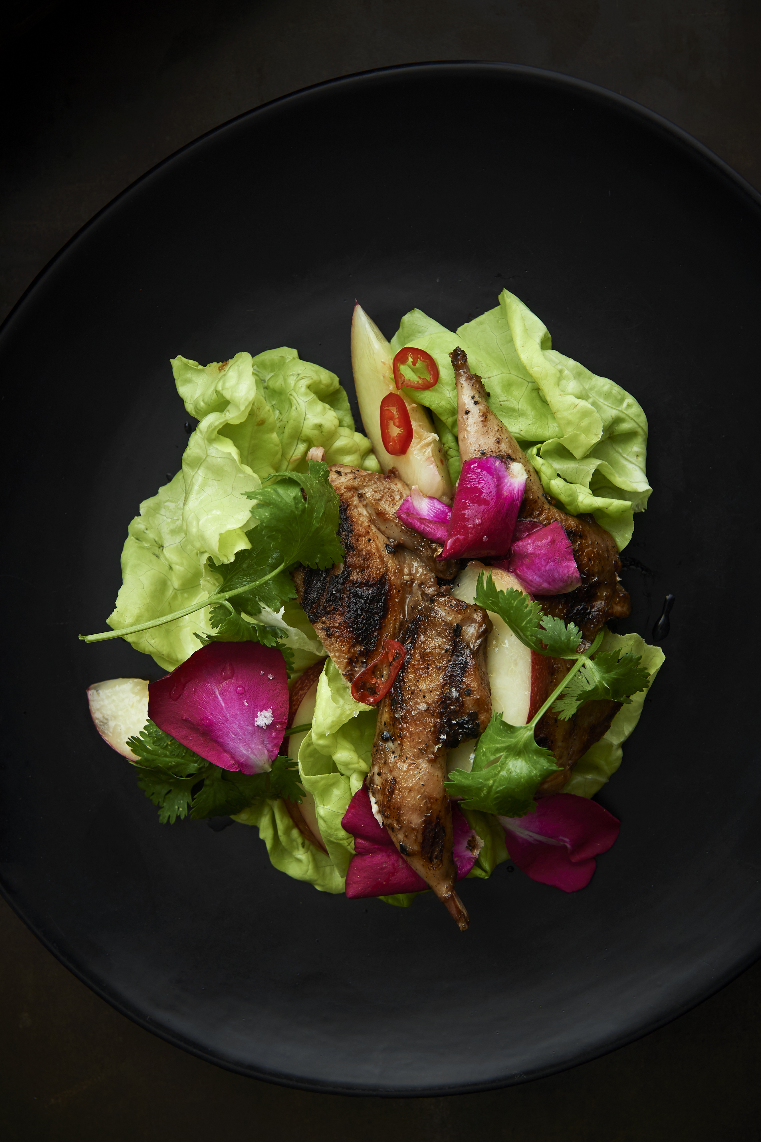 Quail with nectarine and rose petals