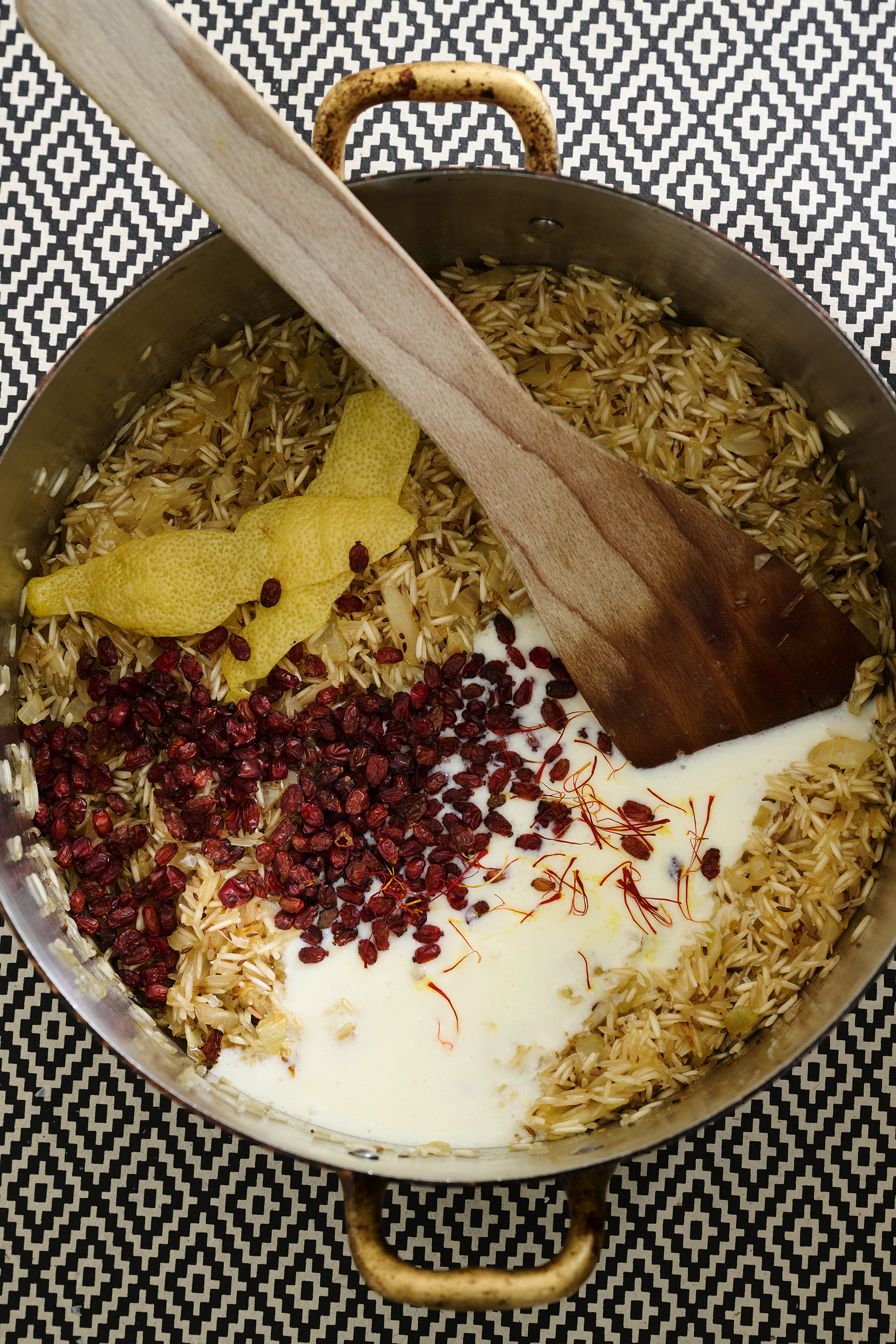 Baked buttered rice with pistachio, cumin, barberries and spinach