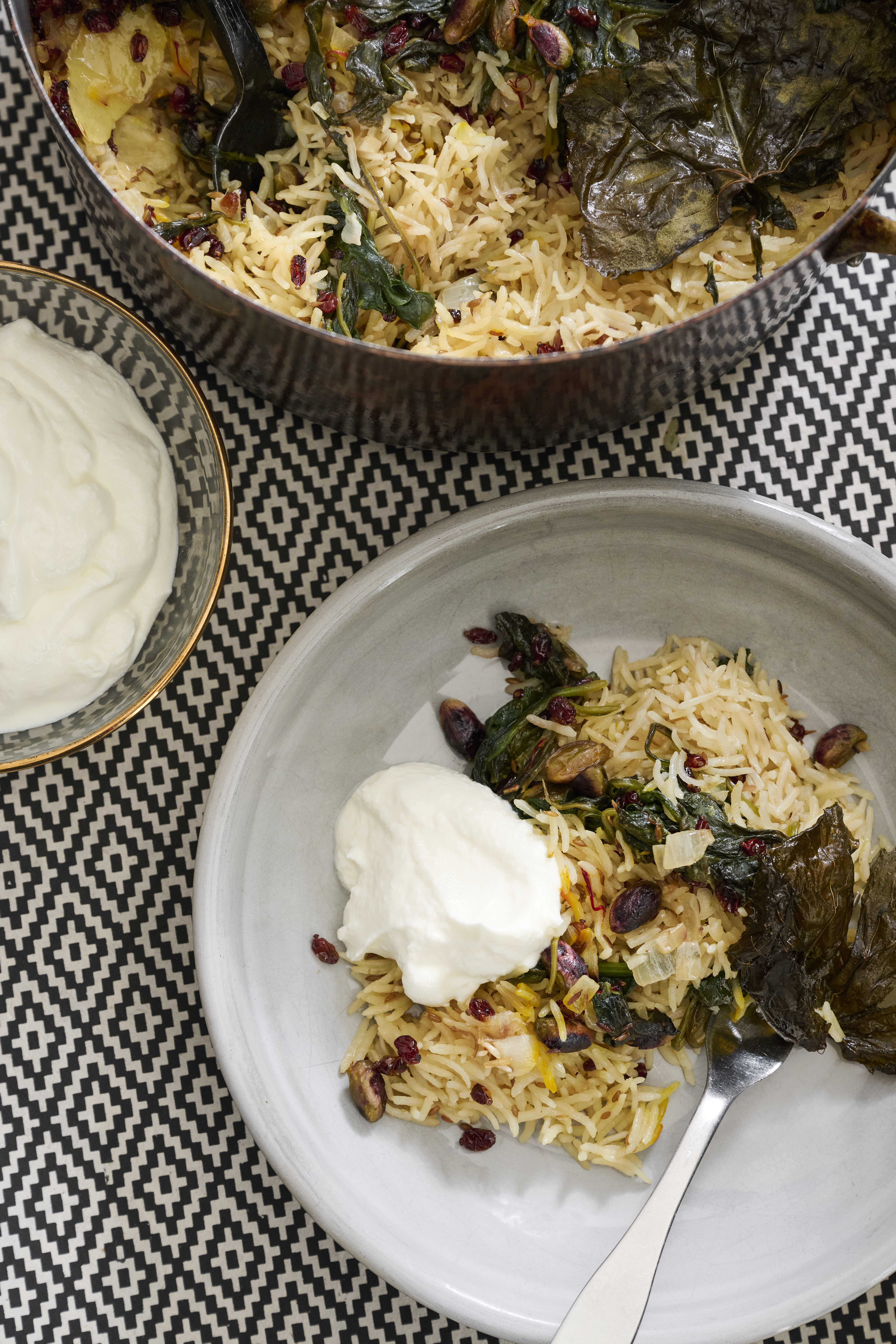 Baked buttered rice with pistachio, cumin, barberries and spinach