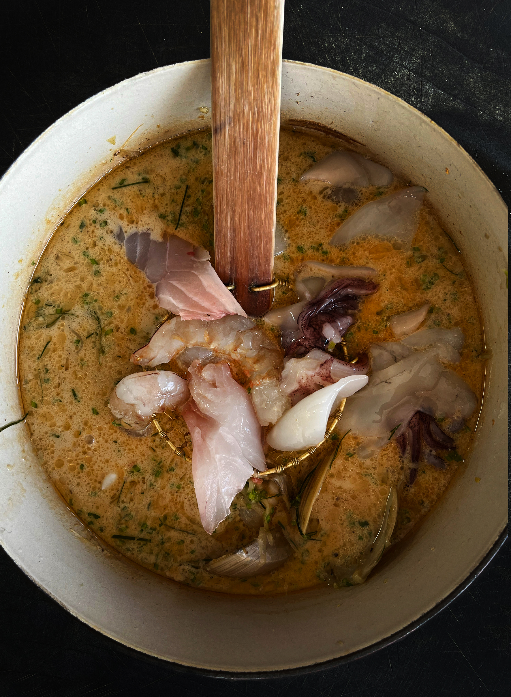 Seafood broth  with green chilli, coconut and lime