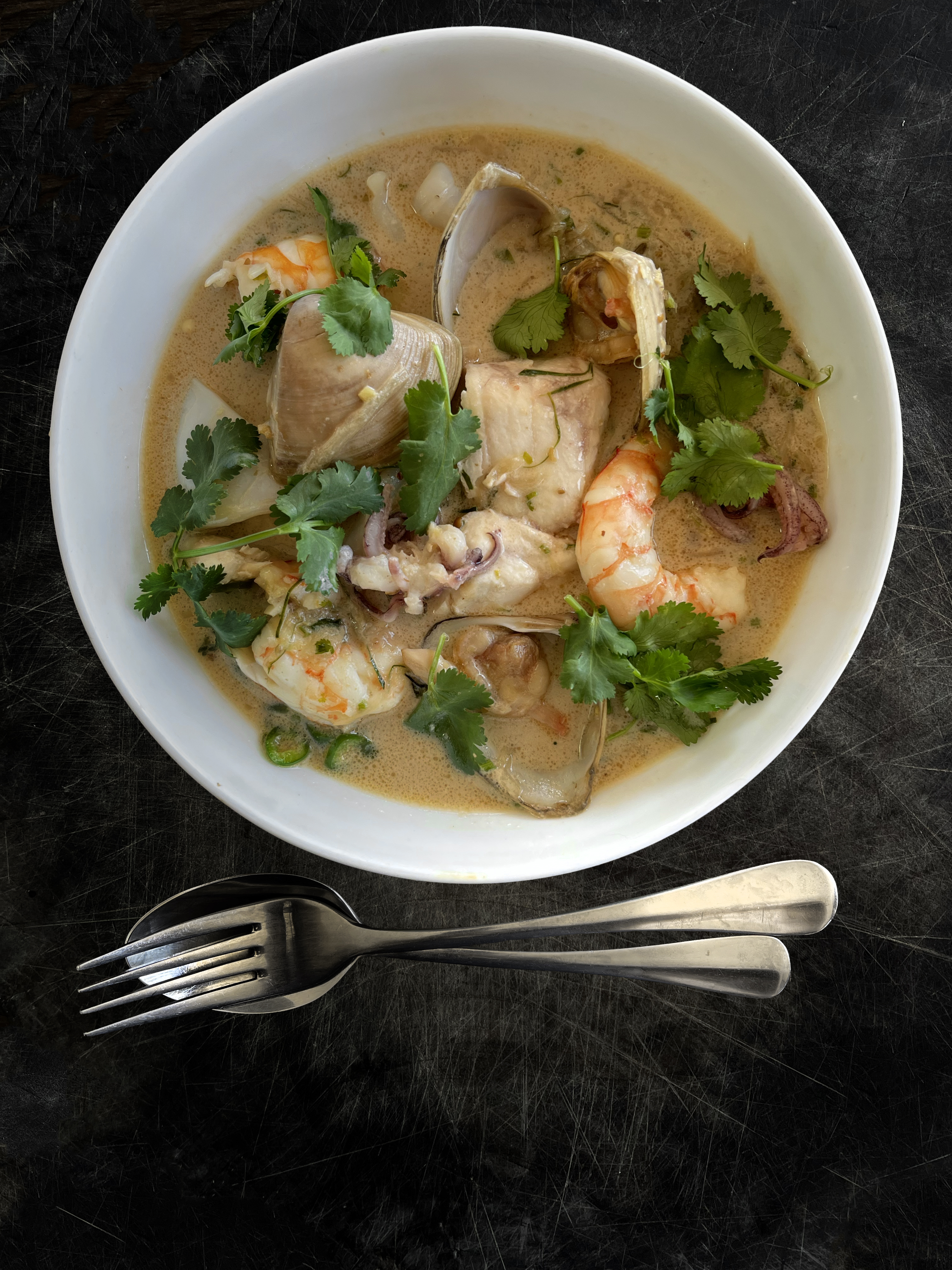 Seafood broth  with green chilli, coconut and lime