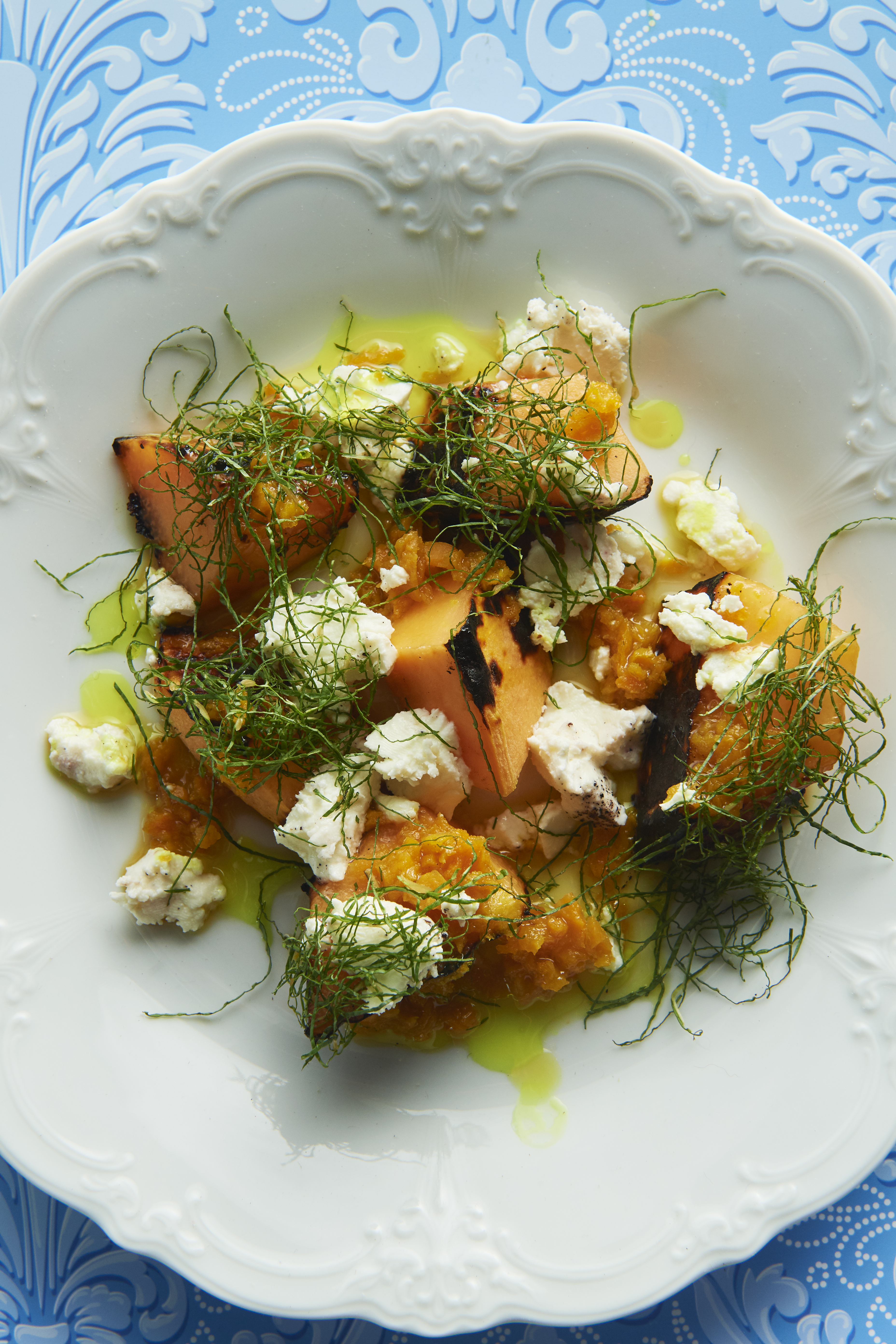 Grilled rockmelon with turmeric, fetta and mint