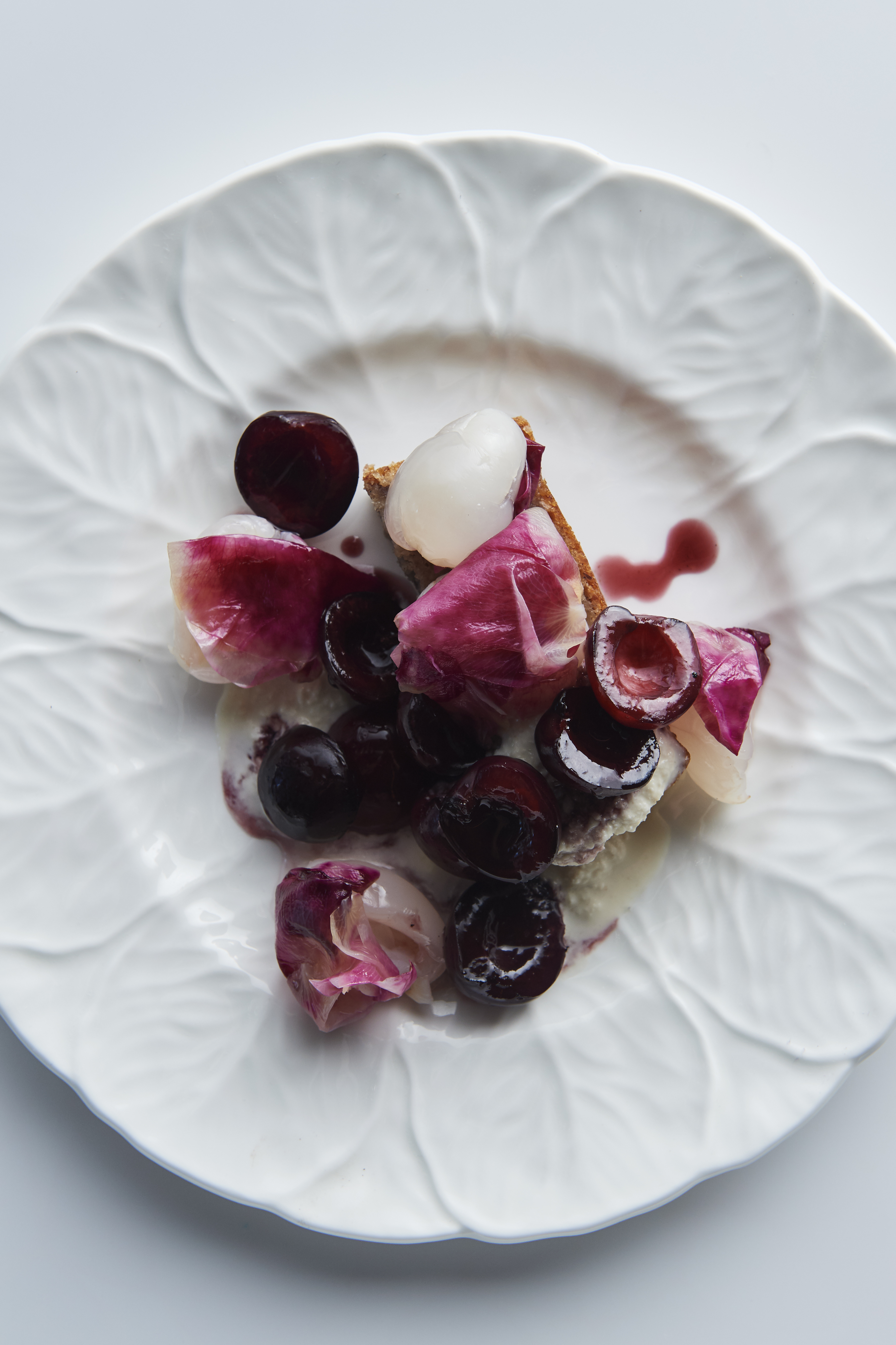 Lychees, cherries and rose petals with tahini and sesame cake