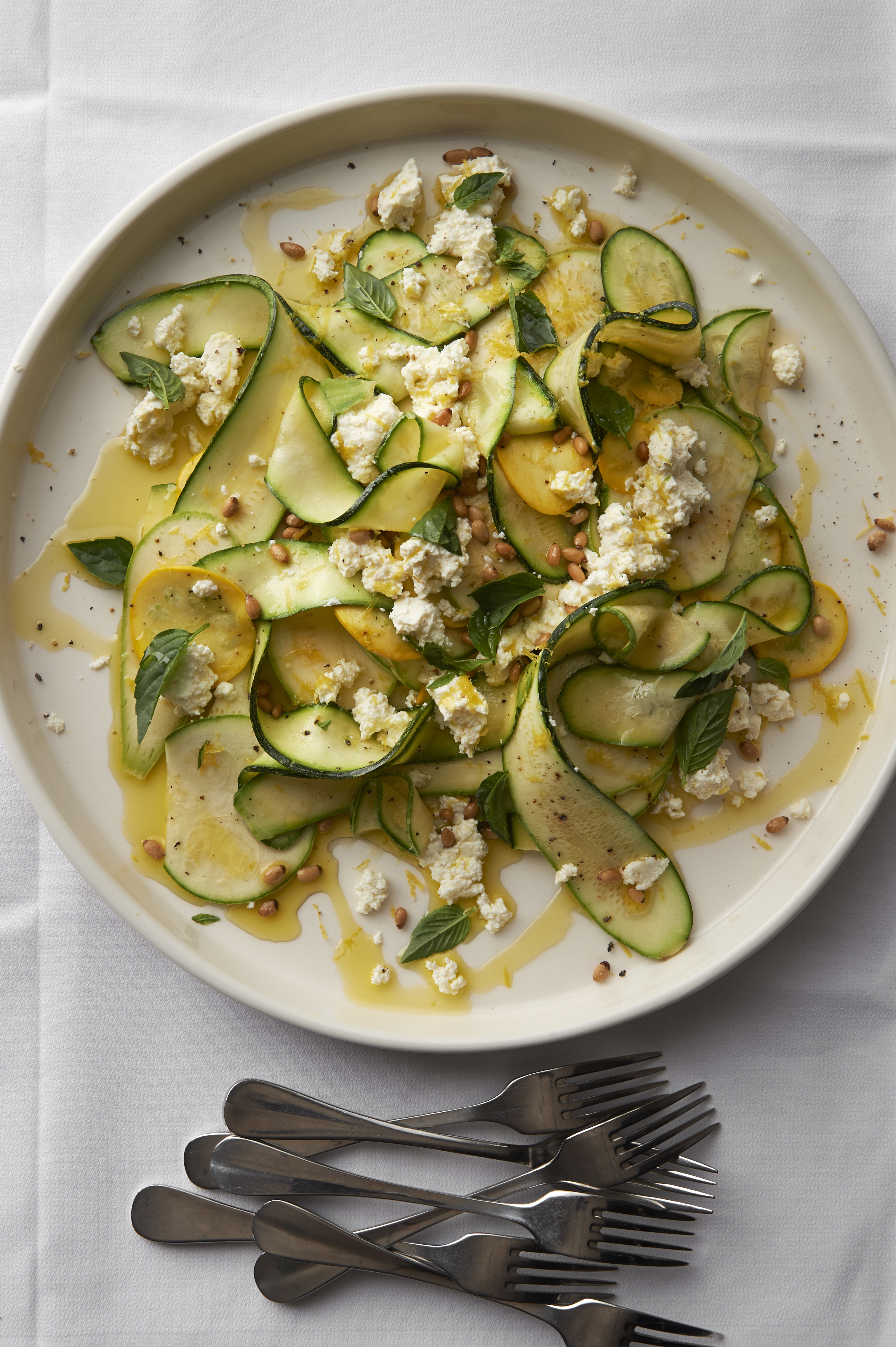 Raw zucchini salad with pine nuts and ricotta