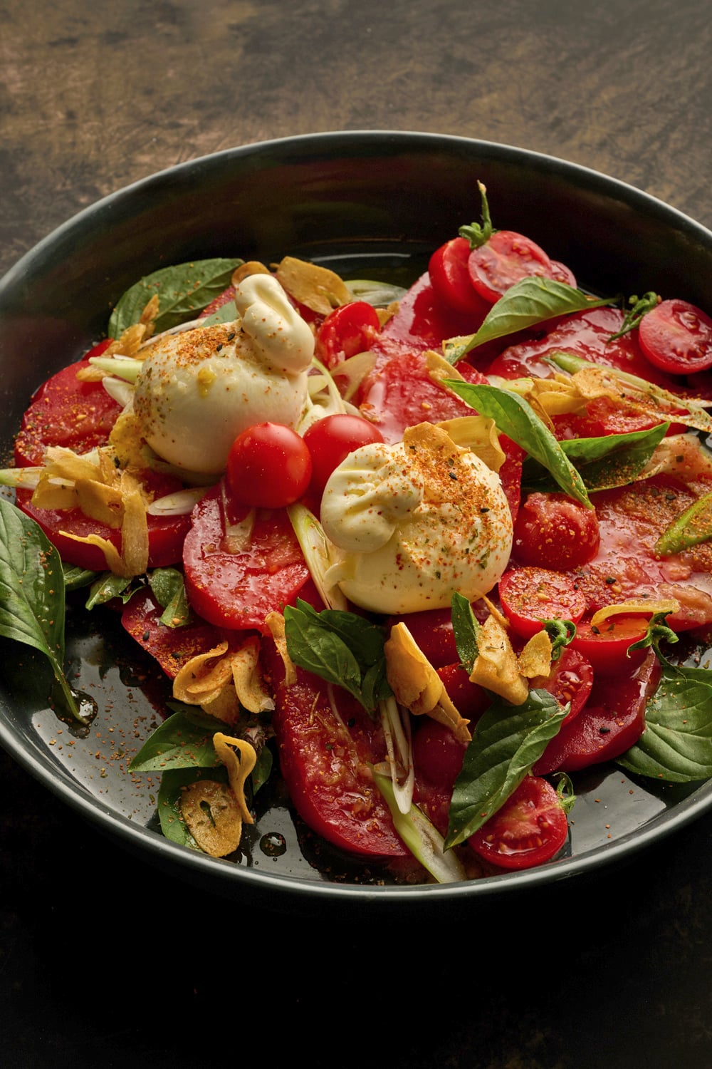 Burrata and tomato salad with sorrel and sesame dressing and crispy garlic oil