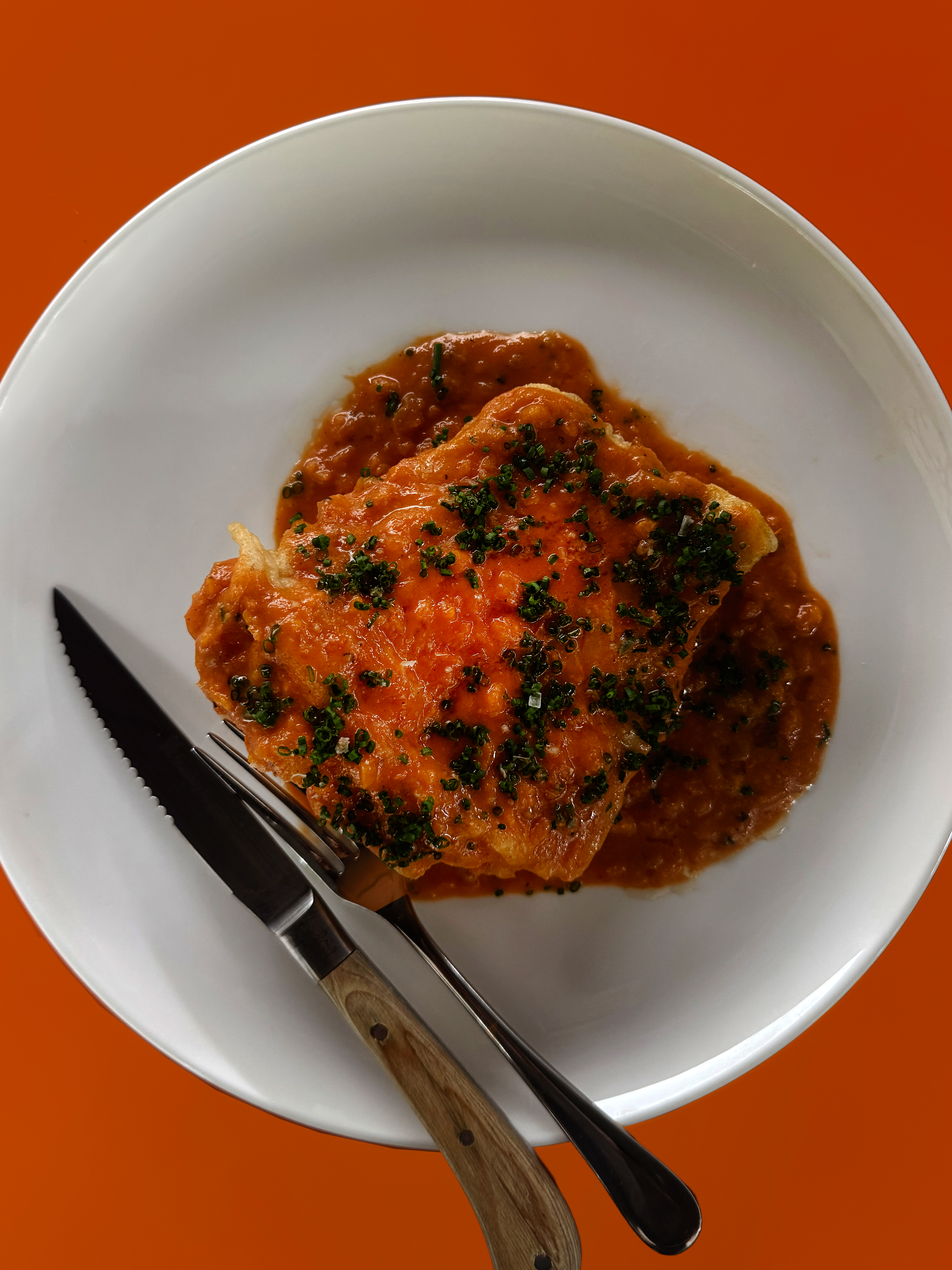 Fried blue-eye in tomato butter sauce