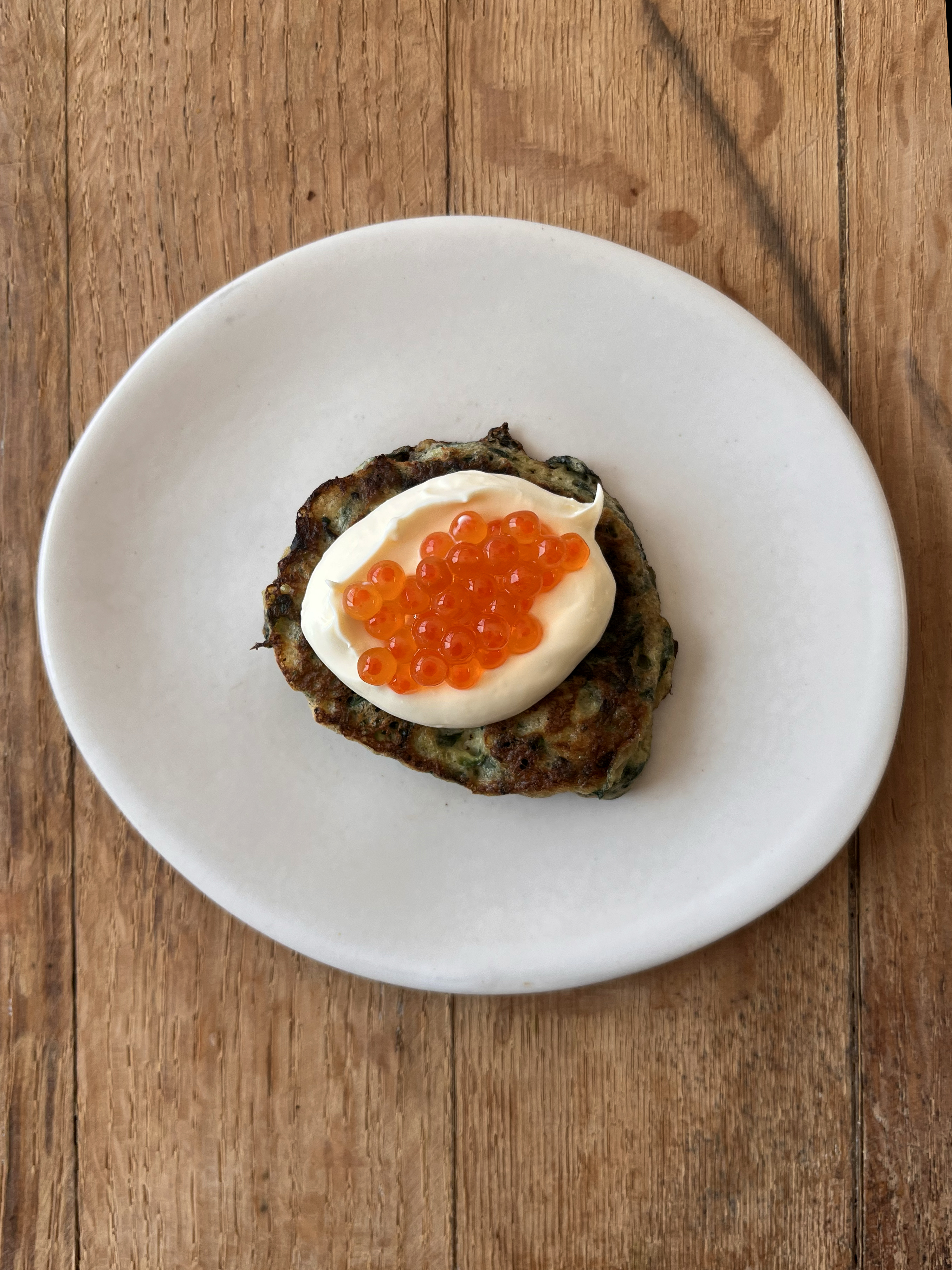 Zucchini pancakes with crème fraîche and salmon roe